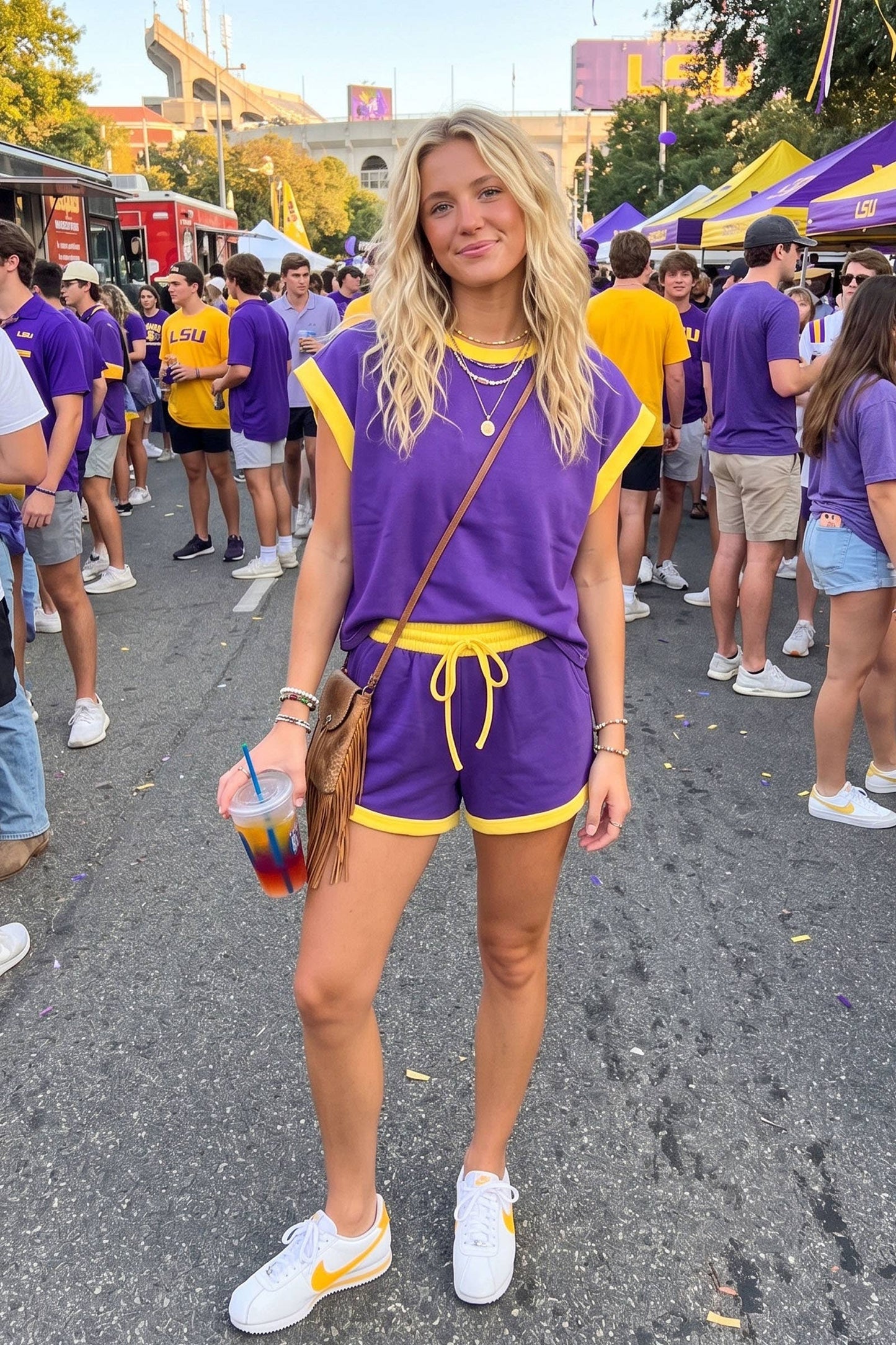 Women Wearing a Purple and Gold 2 piece shorts set at an LSU tailgate