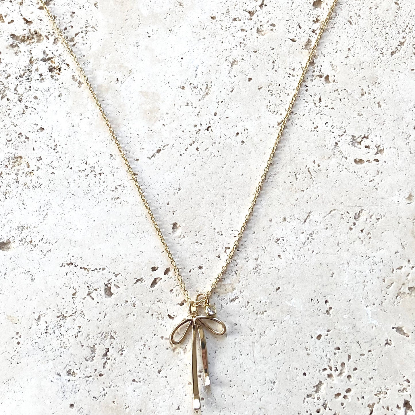 Melted droopy ribbon bow charm necklace