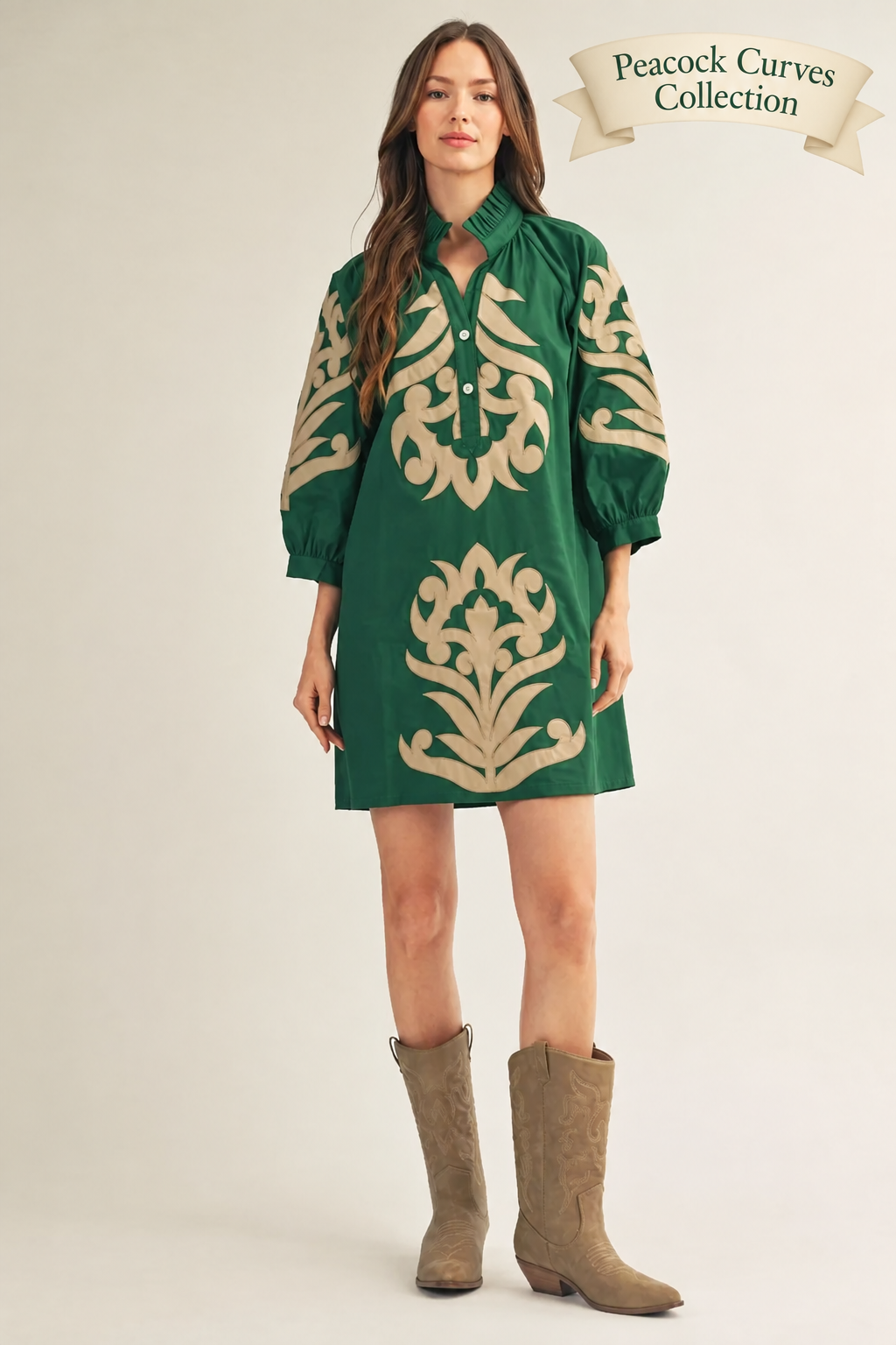 Woman wearing a green dress with beige patterns and brown boots on a white background