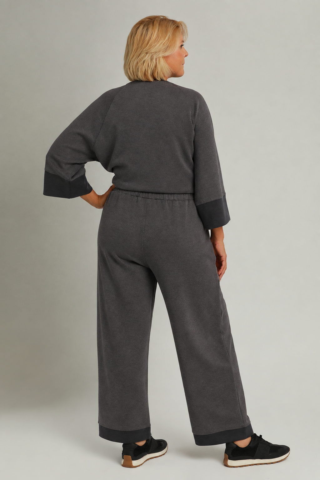 Model wearing a charcoal color-block CloudKnit outfit
