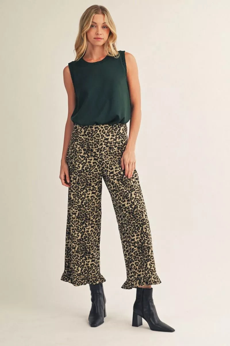Hunter green sleeveless tank with leopard print pants and black booties
