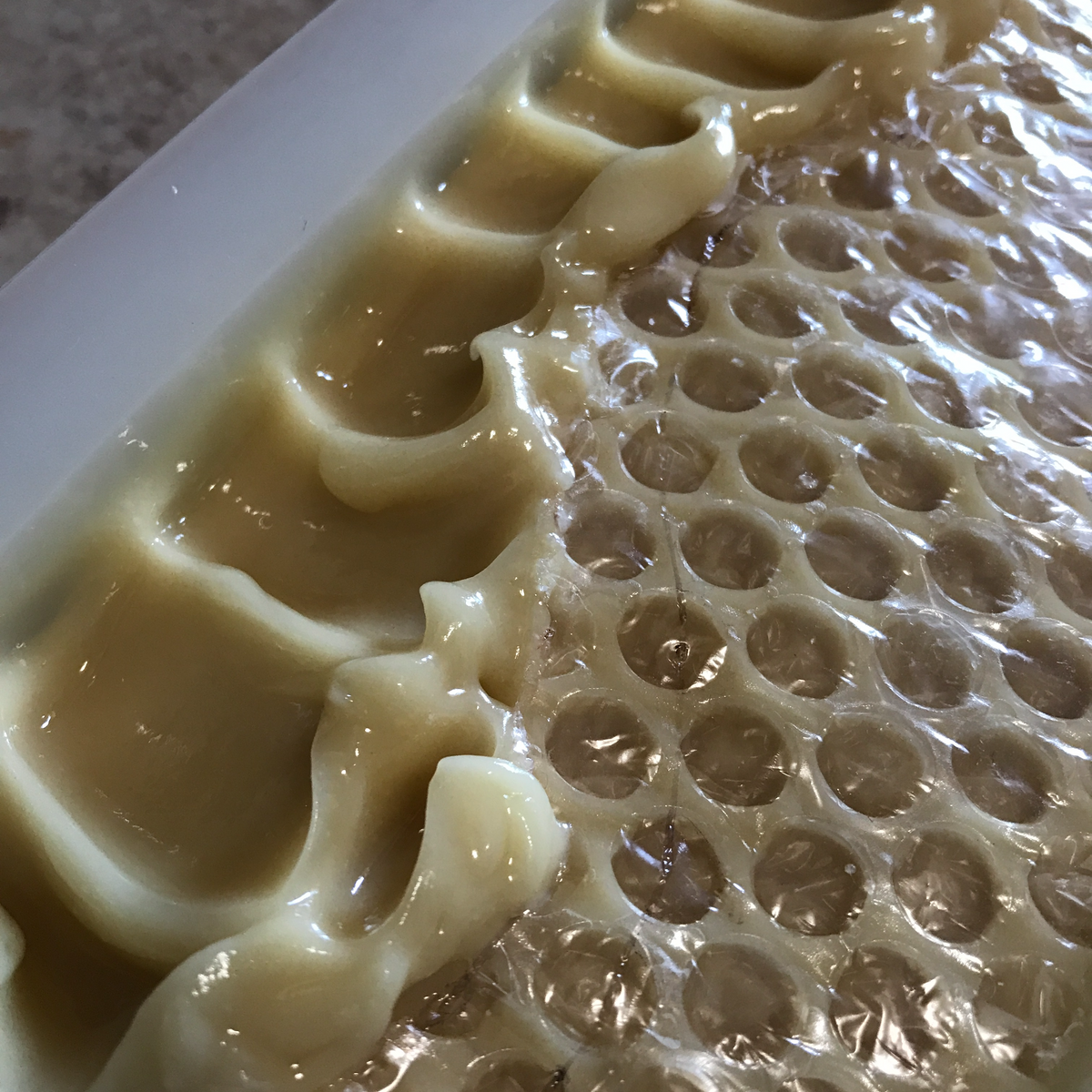 Oatmeal Honey soap with a honeycomb pattern on top