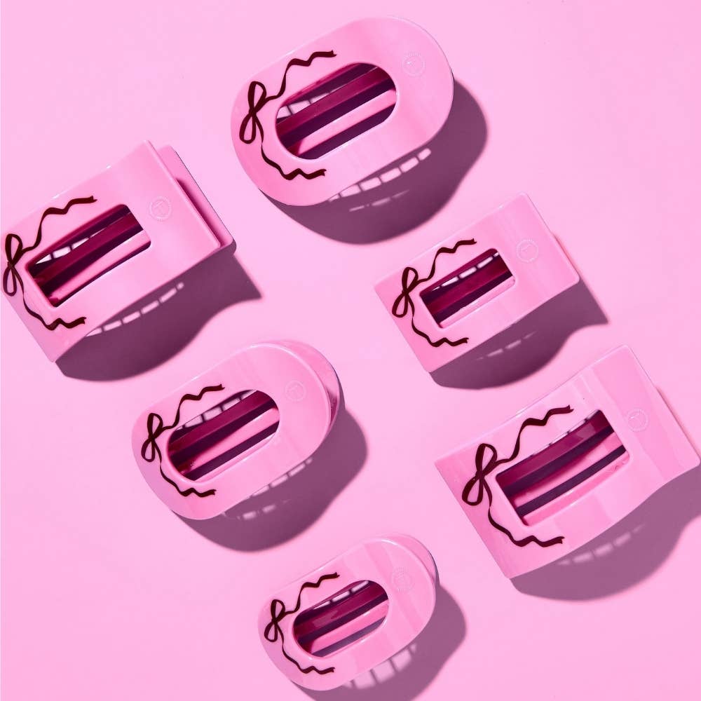 Pink Just Add a Bow flat clips scattered on a pink background