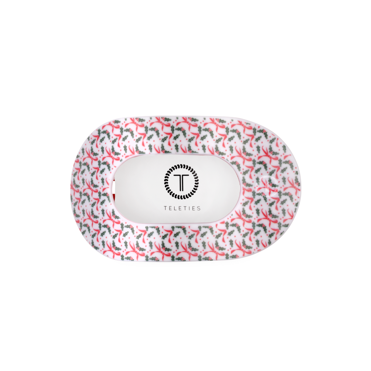 Underside of the Festive Feels holly print medium flat round hair clip showing the TELETIES logo