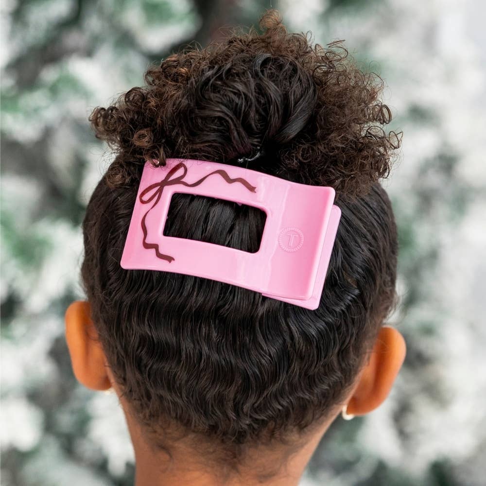 Woman wearing the pink Just Add a Bow small flat rectangle hair clip in an updo
