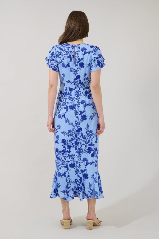 Woman wearing a blue floral dress on a white background