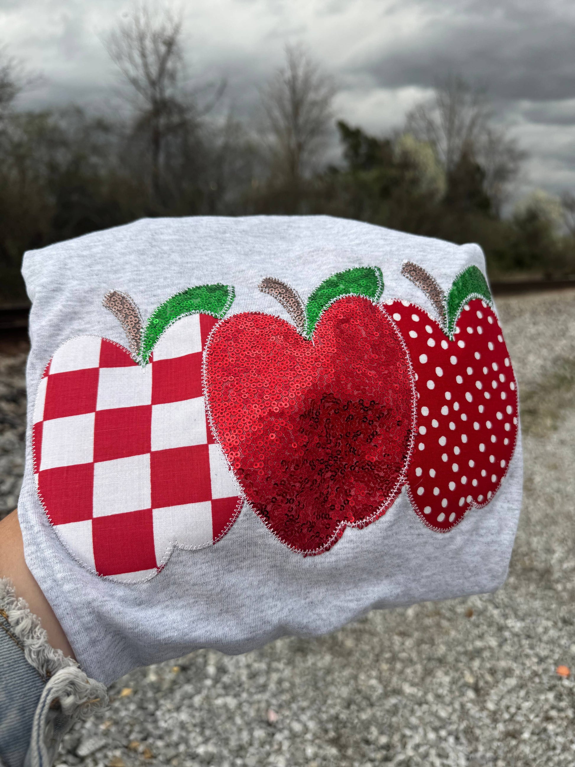 Gray t-shirt with red and white apple designs 