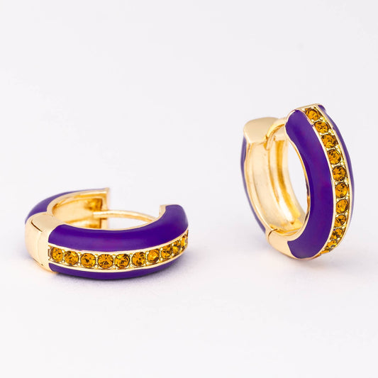 Pair of gold hoop earrings with purple bands and yellow gemstones on a white background