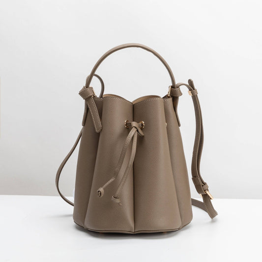 Beige leather bucket bag on a white background