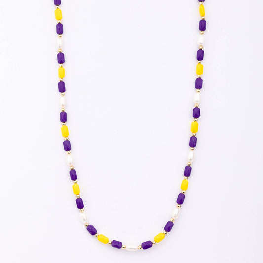 Necklace with purple and yellow beads on a white background