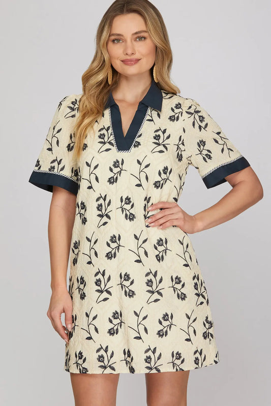 Woman wearing a floral dress with a plain background