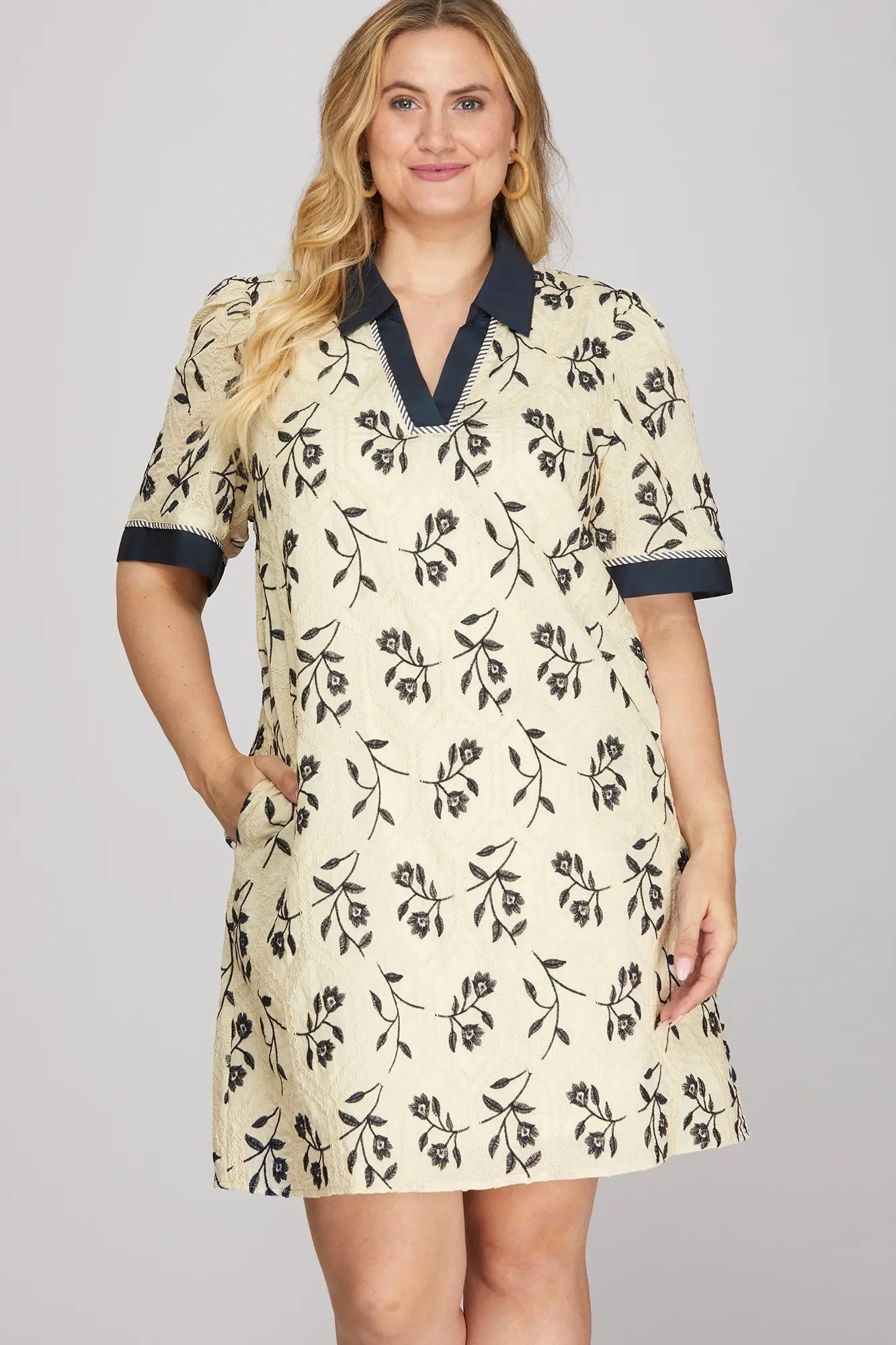 Woman wearing a floral dress with a plain background