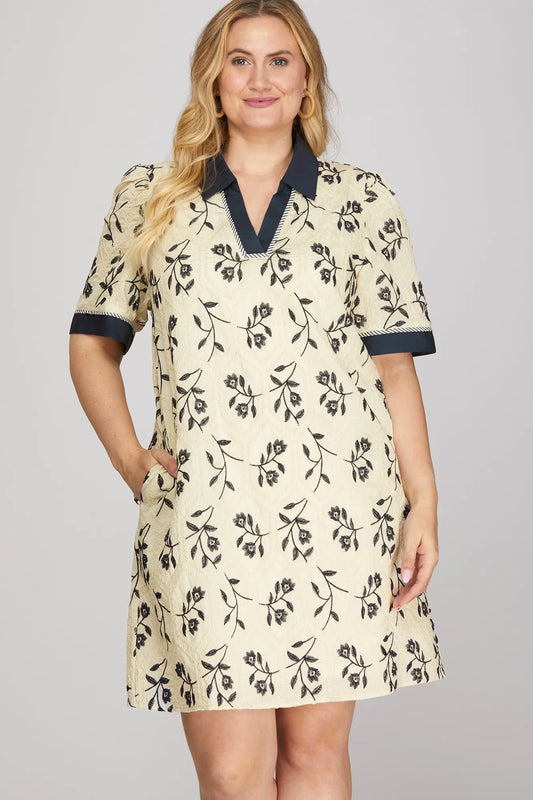 Woman wearing a floral dress with a plain background