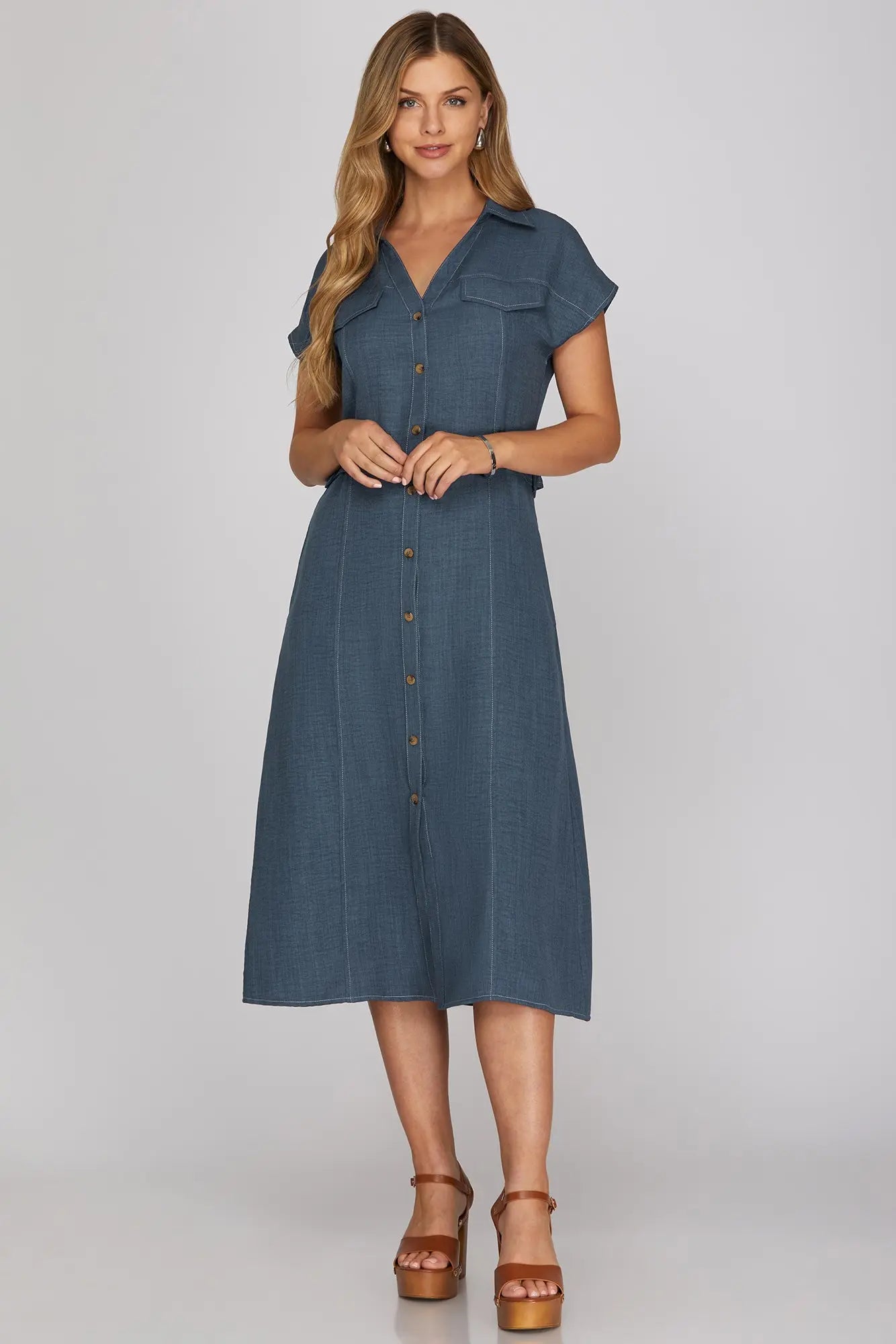 Woman wearing a blue dress on a gray background