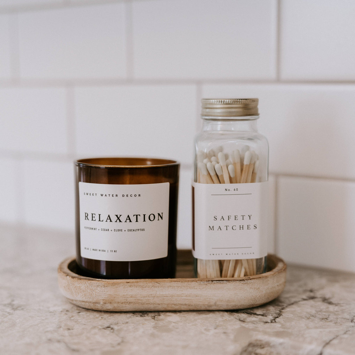White tip safety matches styled beside a candle on a counter