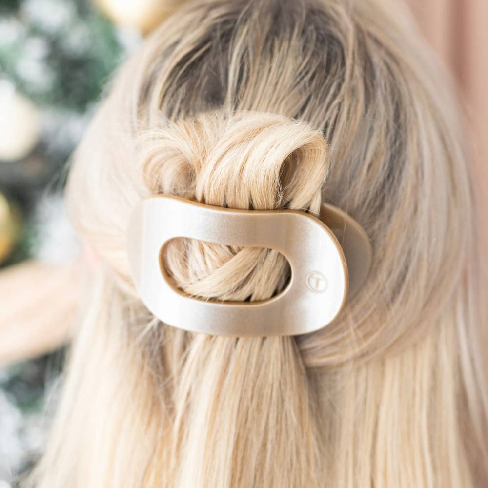 Woman wearing the flat round hair clip from the holiday ornament