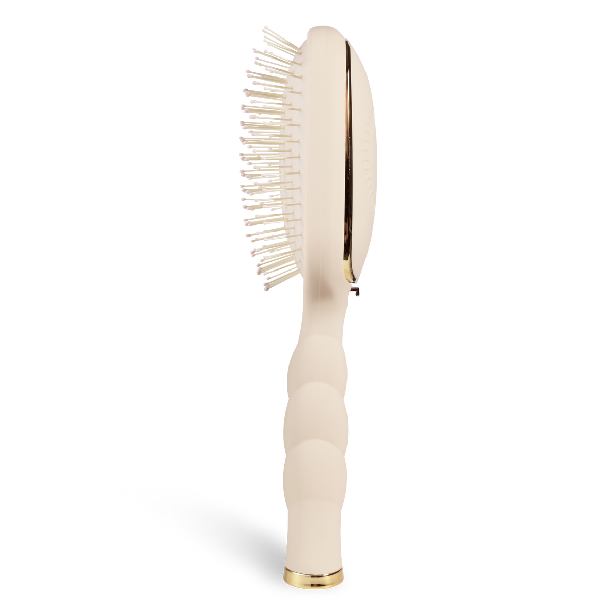 Side view of the tan detangler brush for medium hair and its coil handle