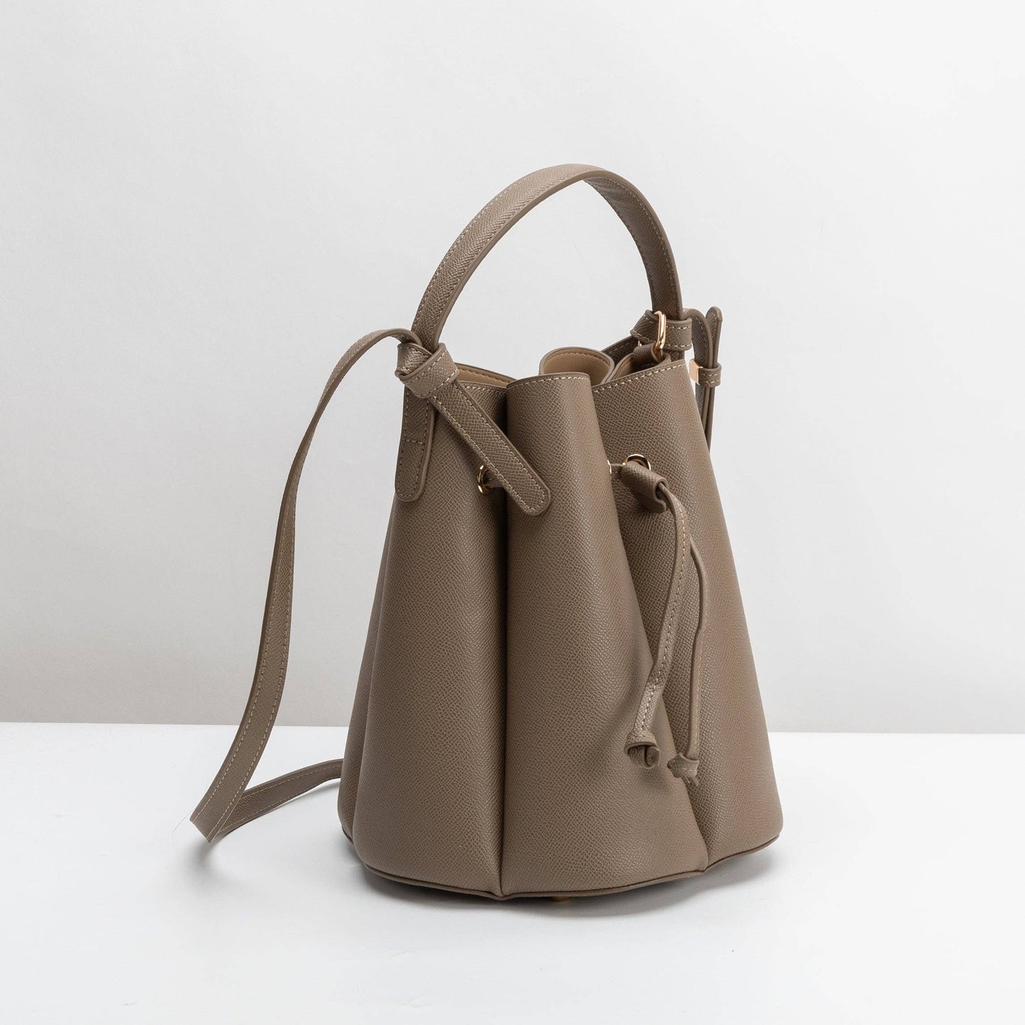 Brown leather bucket bag on a white background