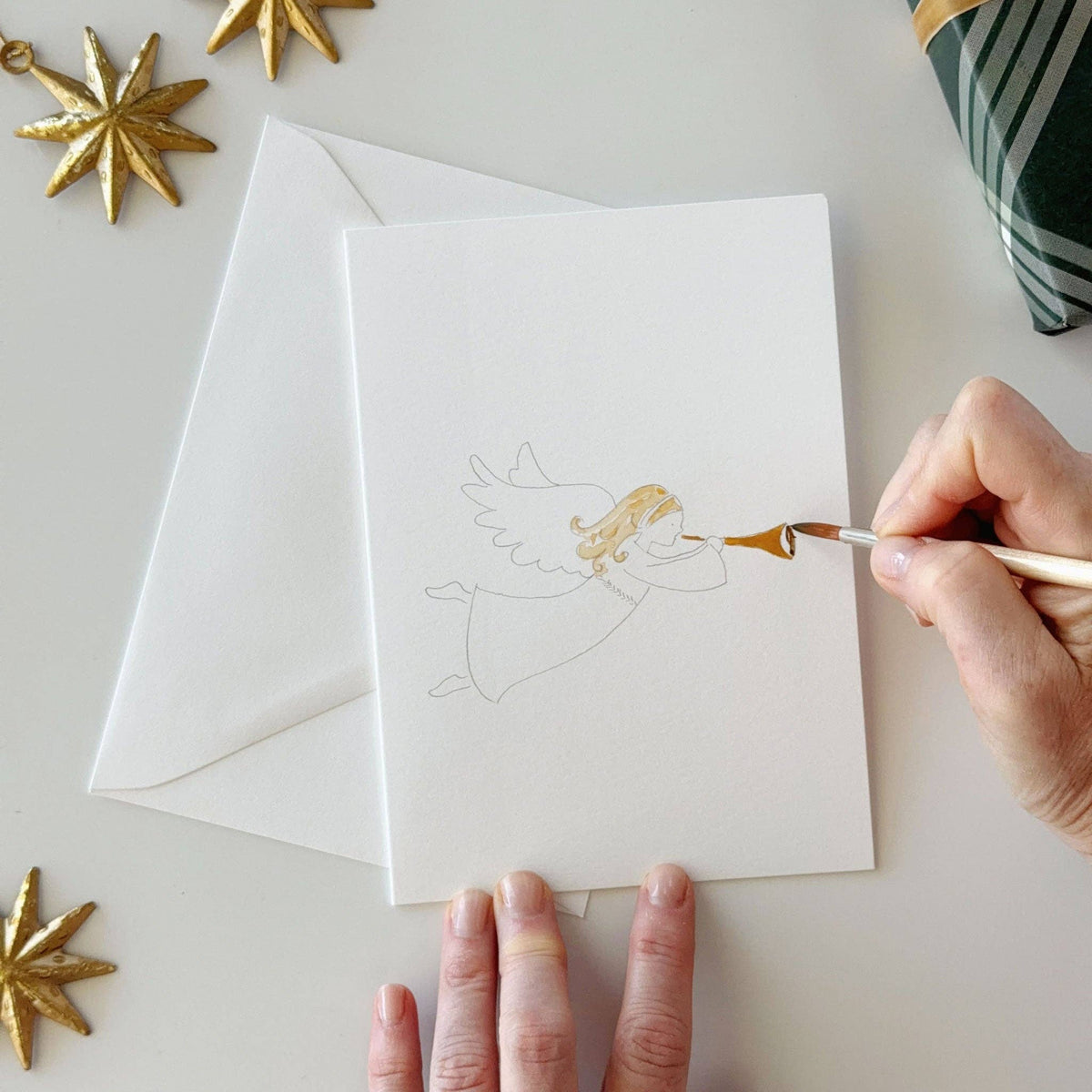 Painting an angel on a nativity notecard