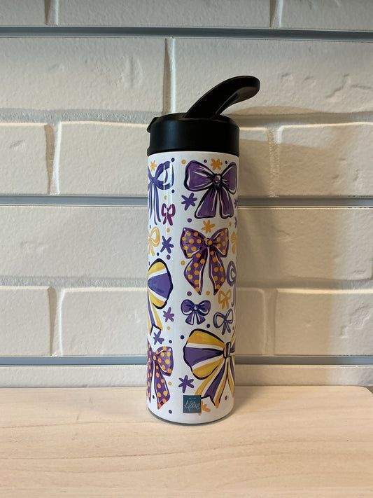 Colorful water bottle with purple and yellow designs on a glass surface