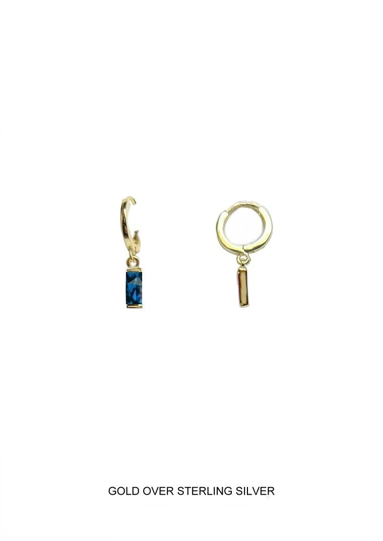 A pair of gold hoop earrings with small dangling charms,