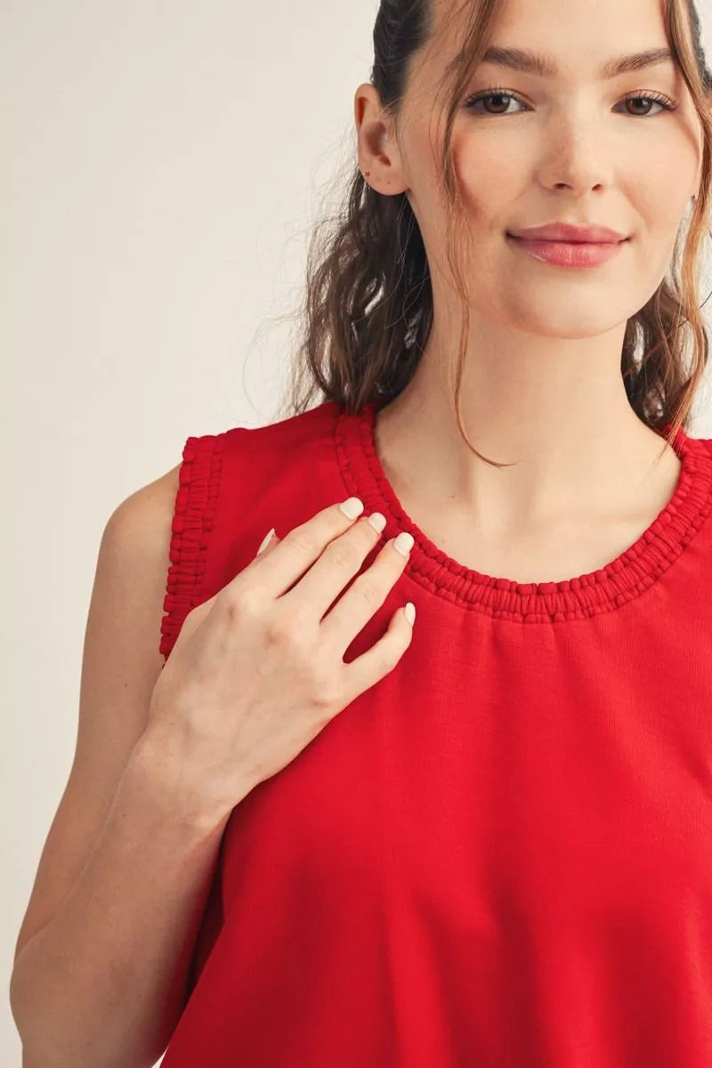 Close-up of the smocked edge detail at the red tank's neckline