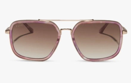 A pair of aviator-style sunglasses with a translucent pink and purple acetate frame, gold metal double bridge, and brown gradient lenses, shown against a plain white background.