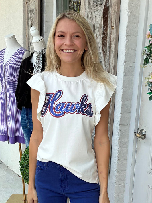 Hawks spirit sequin patch white flutter sleeve tee paired with blue pants and silver sneakers. 