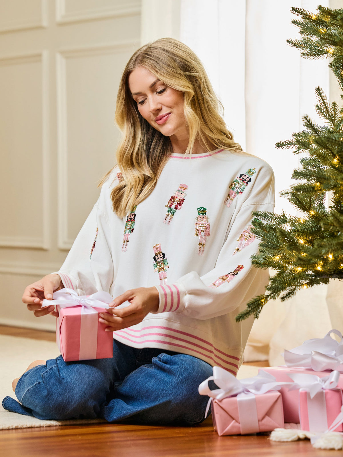 Ivory nutcracker sweatshirt with a wrapped gift