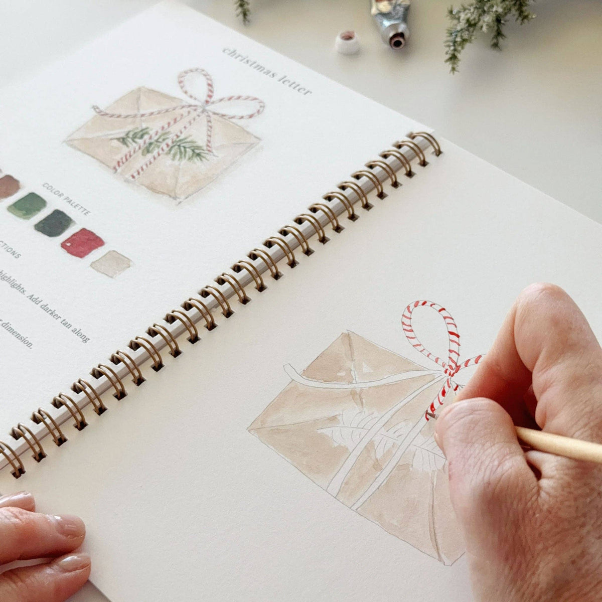 Painting a wrapped present in the watercolor workbook