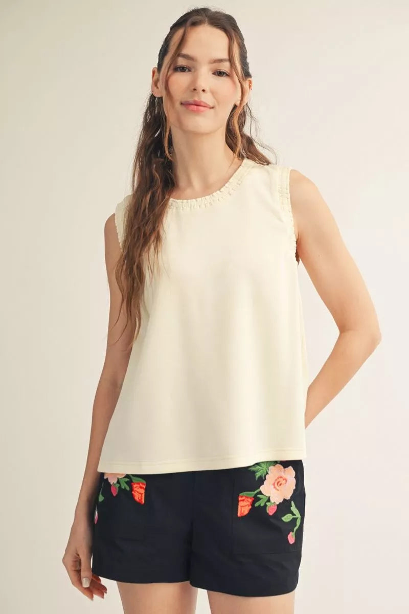 Ivory sleeveless smocked edge tank with black floral embroidered shorts