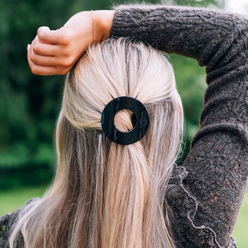Woman wearing the Jet Black small flat circle hair clip in her hair