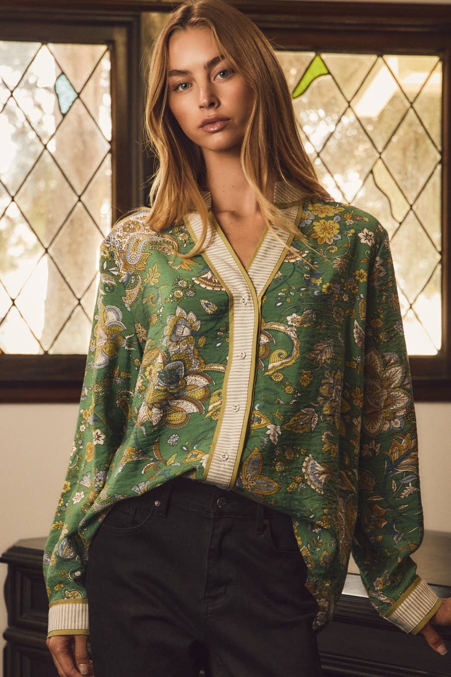Green and gold paisley blouse with split neckline, contrast placket and cuffs, worn with black jeans