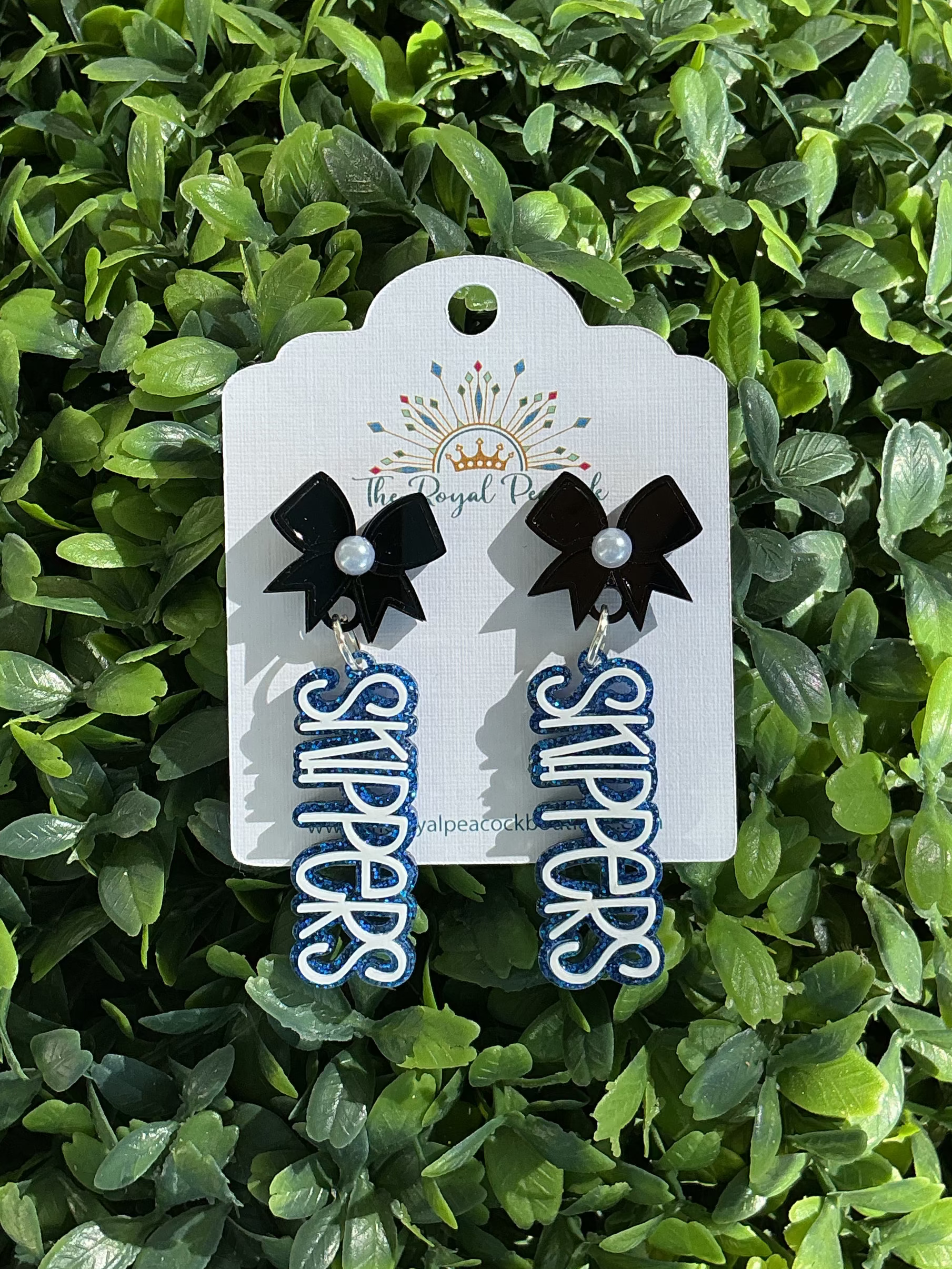 MHS Skippers bow dangle earrings with Skippers script drops on a display card