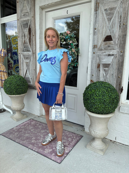 women wearing a light blue top with ruffle sleeves with a Royal Blue and Silver Doves Sequin Patch 