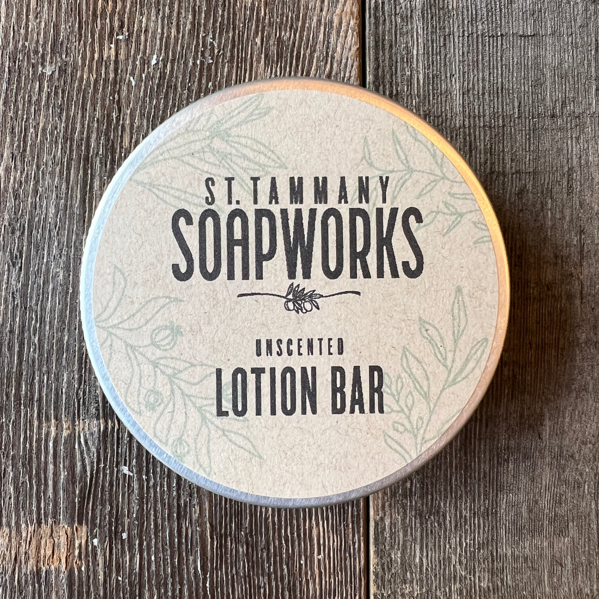 Unscented Lotion Bar tin by St. Tammany Soapworks on rustic wood