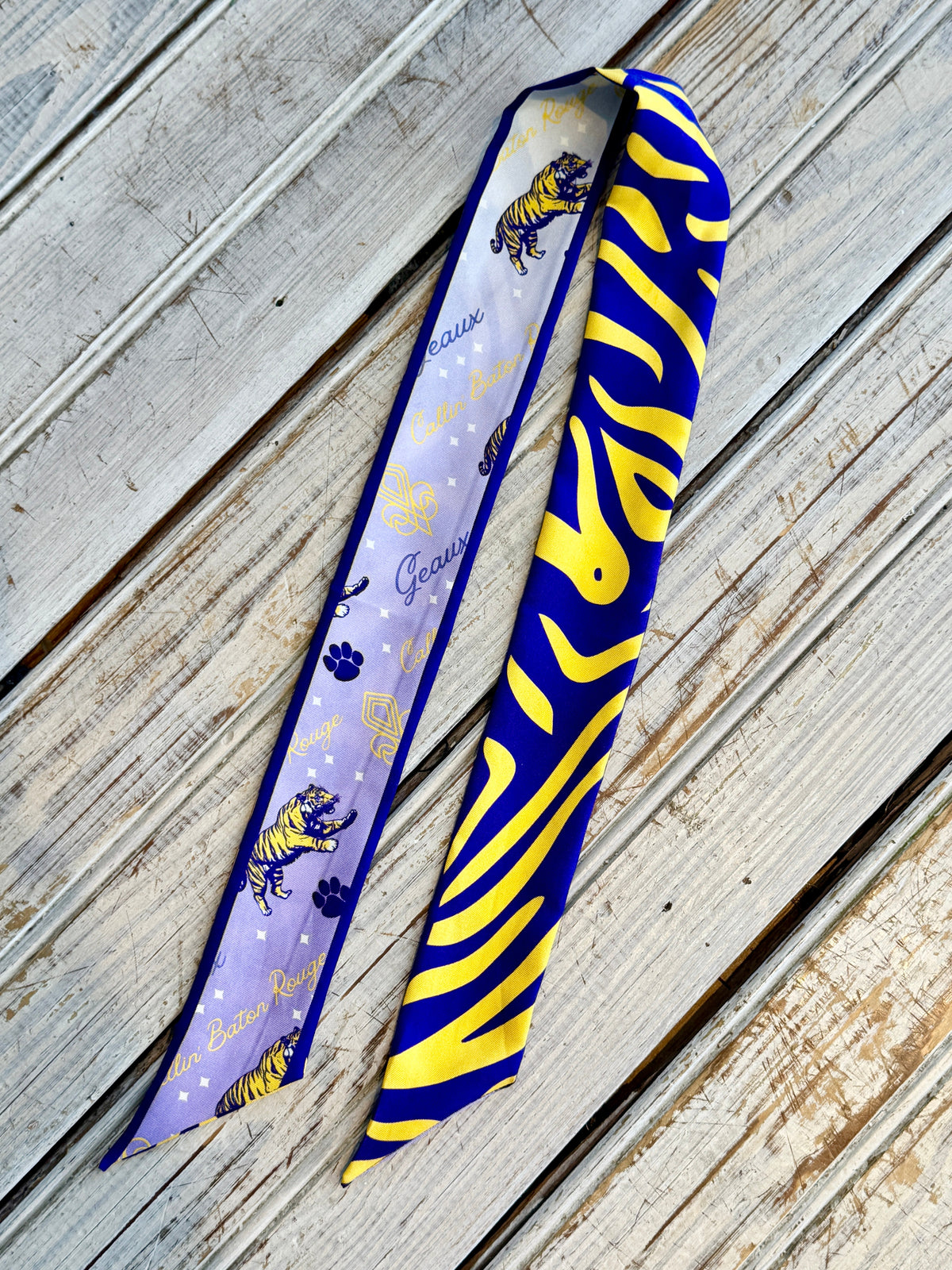 Double-sided purple and gold silk twilly showing tiger stripe and lavender tiger print sides