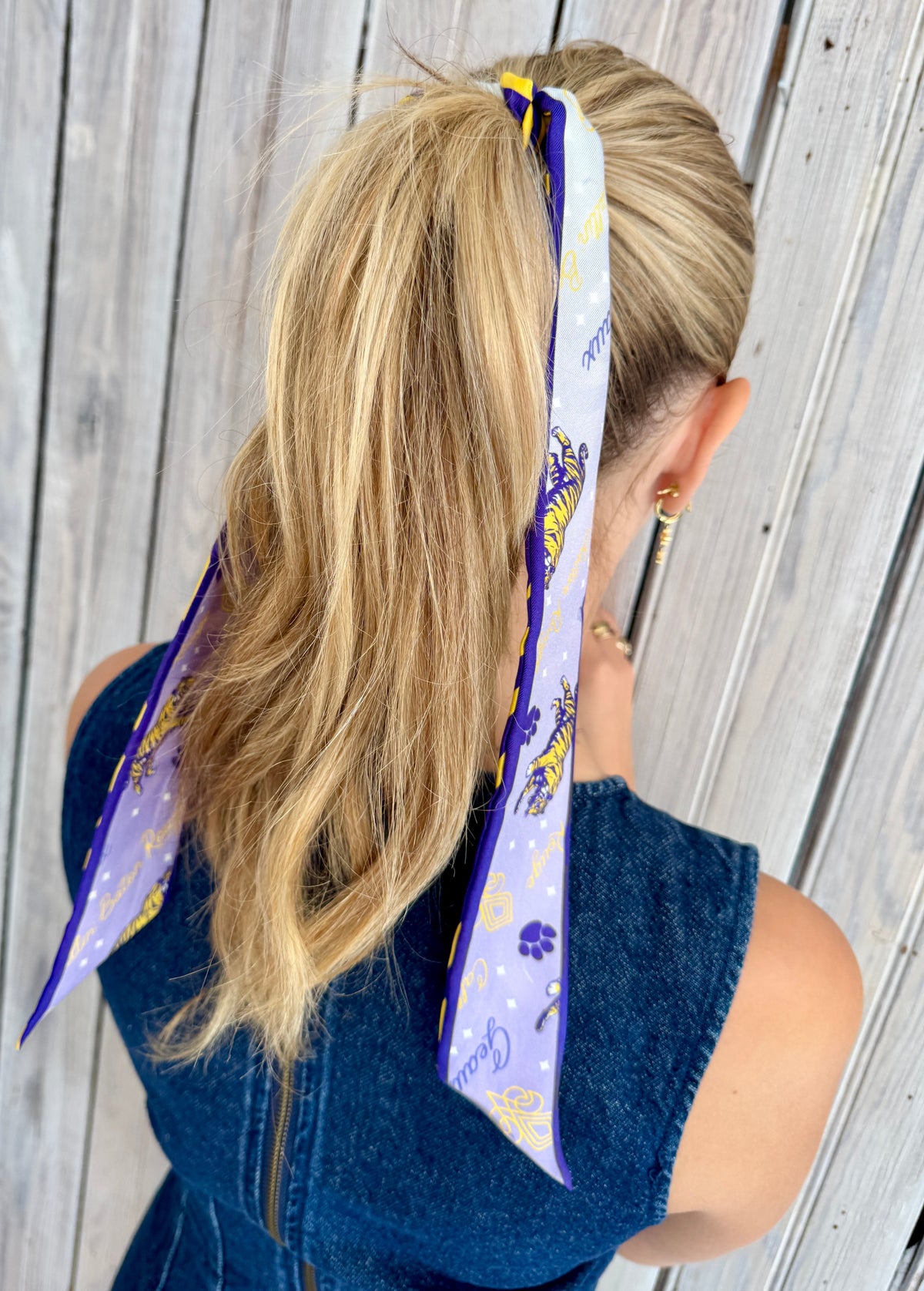Lavender tiger print side of silk twilly tied in a ponytail