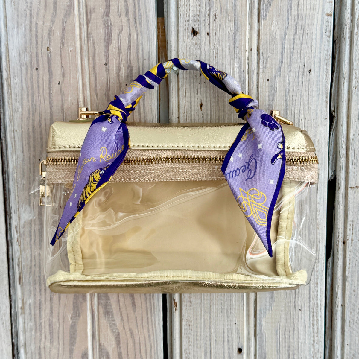 Lavender Geaux tiger silk twilly tied on the handle of a clear bag