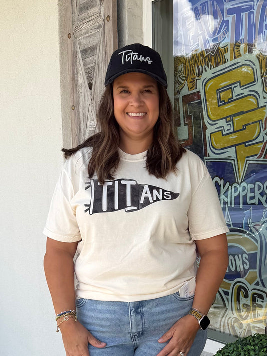 A women wearing an Ivory color t shirt with graphic pennant flag that says titans