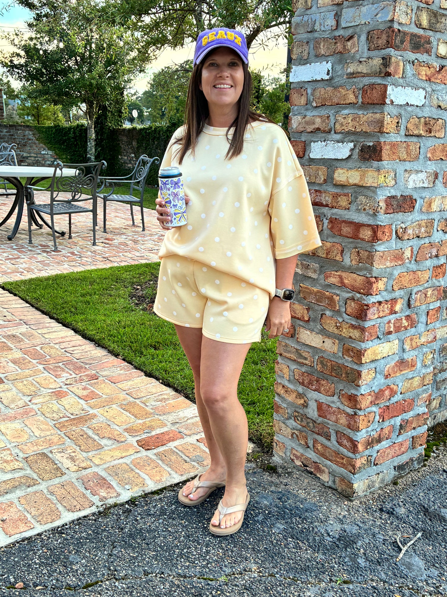 Women wearing 2 peice shorts set pale yellow with white polka dots