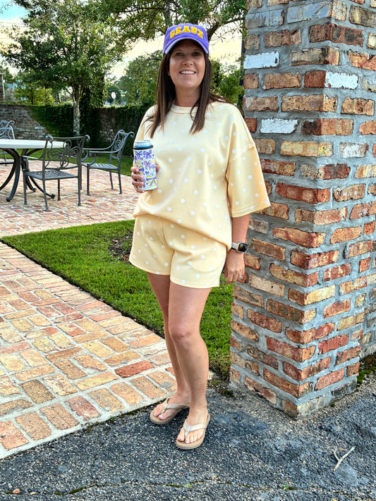 Women wearing 2 peice shorts set pale yellow with white polka dots