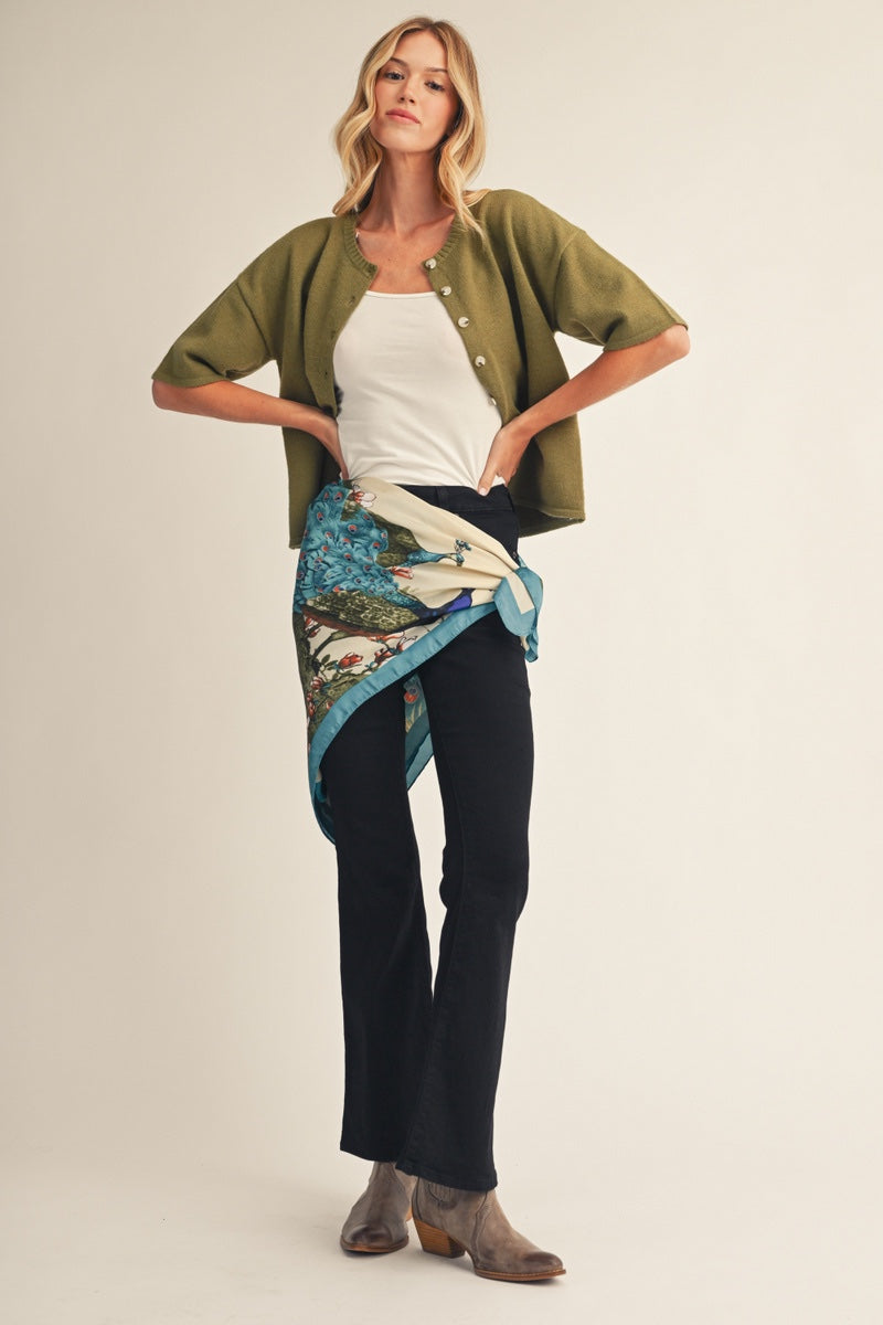 women with a peacock scarf wrapped around waist