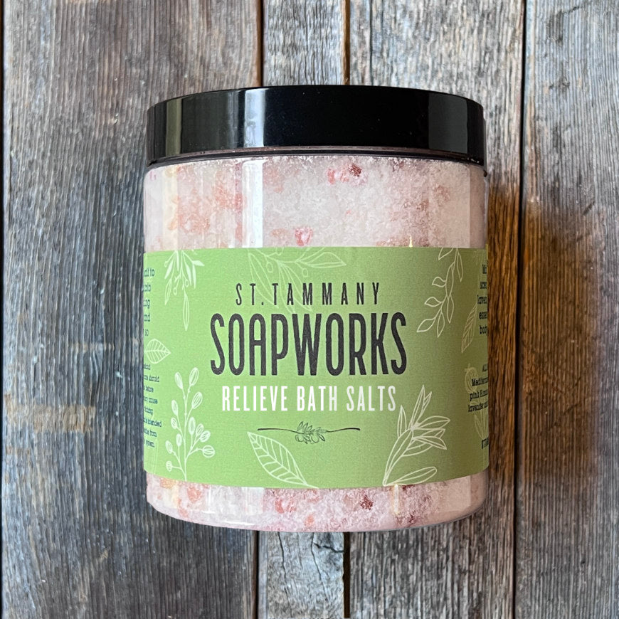 Jar of RELIEVE Bath Salts by St. Tammany Soapworks on rustic wood