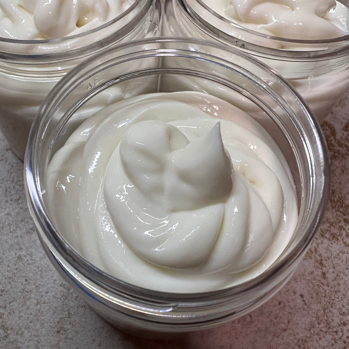 Open jar of smooth white Lavender Magnesium Cream