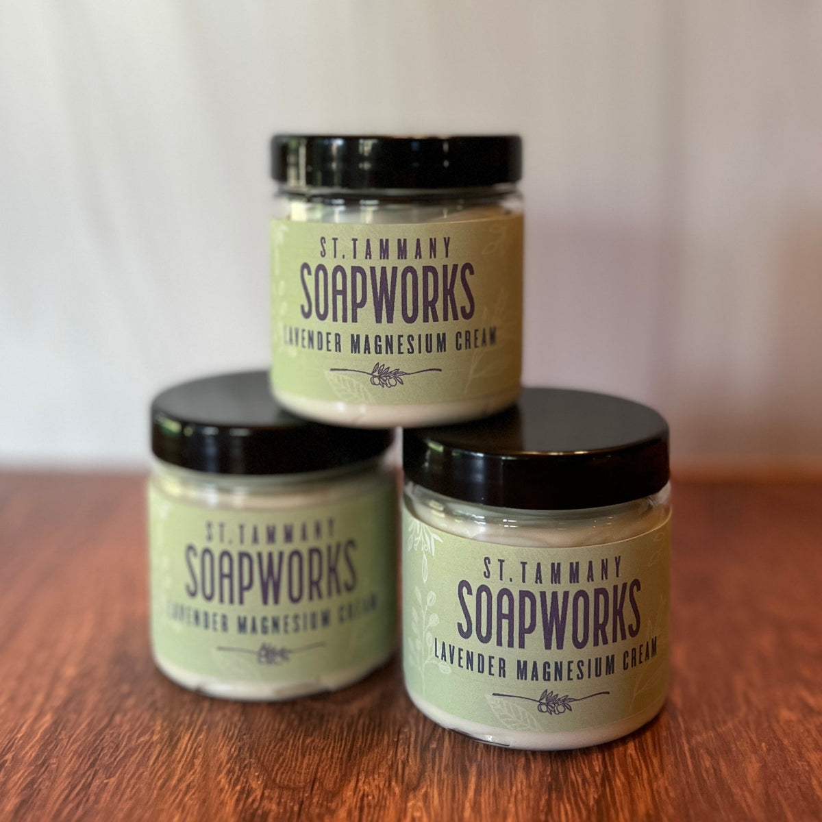 Three stacked jars of Lavender Magnesium Cream