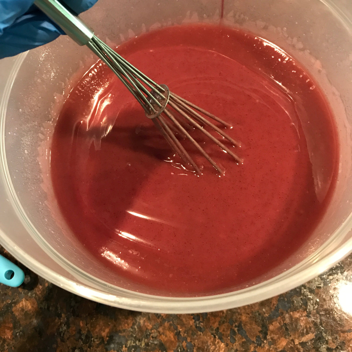 Pink peppermint soap batter being whisked in a bowl