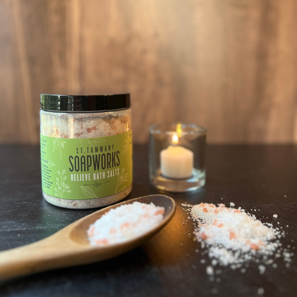 RELIEVE Bath Salts jar with a candle and a scoop of salts