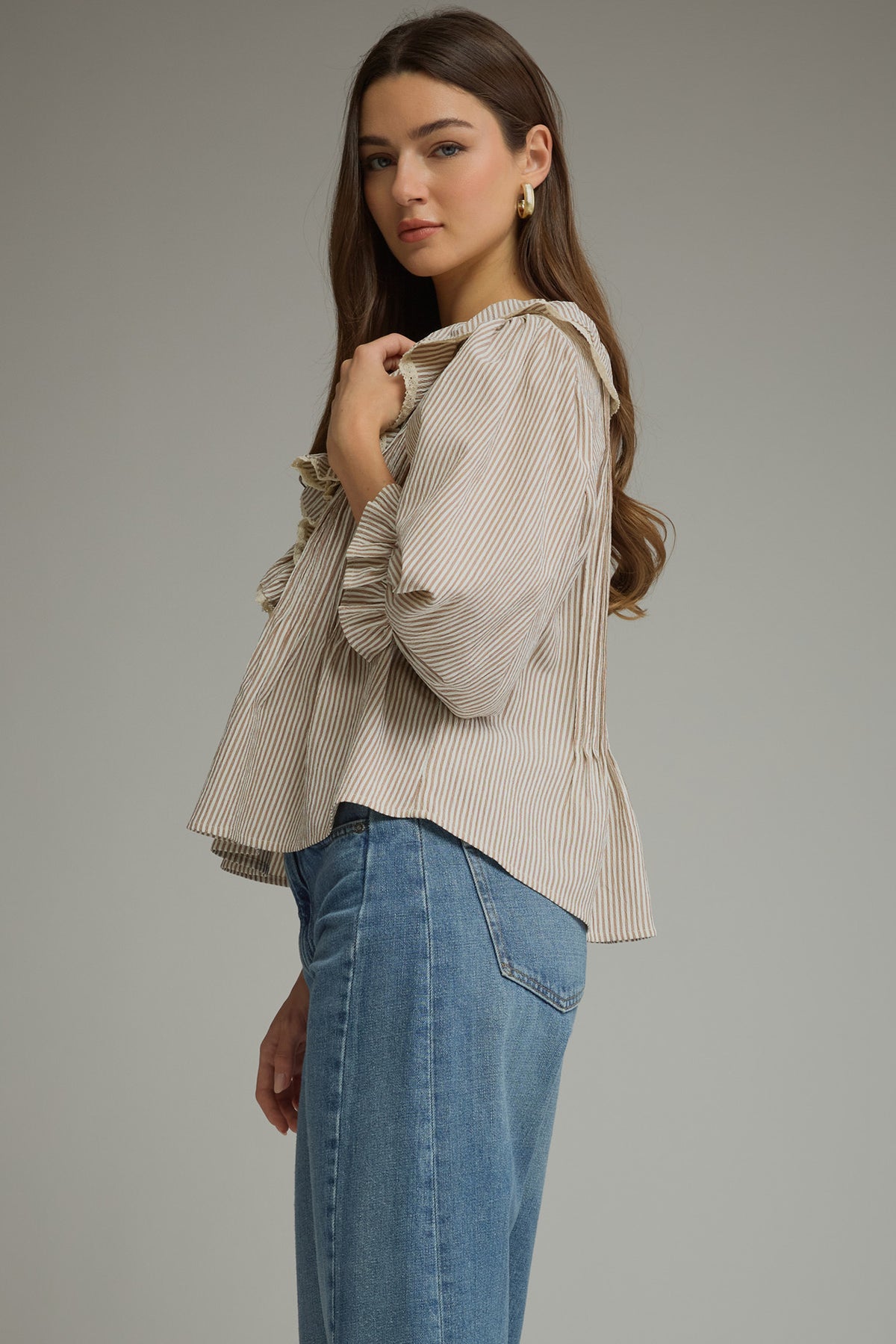 Side view of brown pinstripe ruffle blouse with 3/4 balloon sleeves