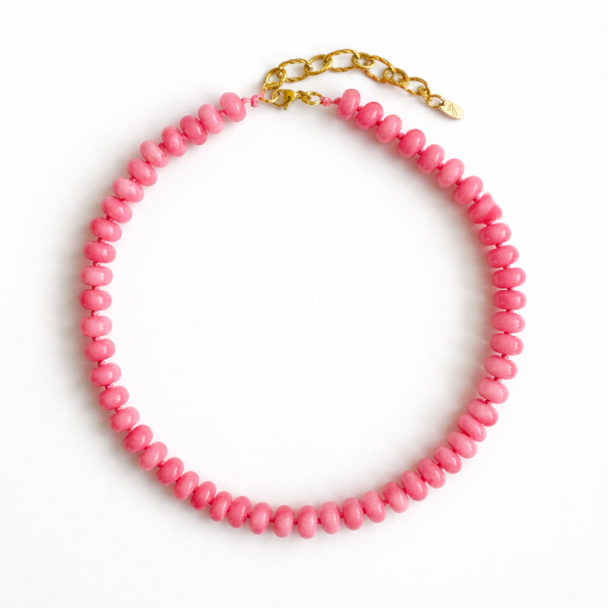 Necklace with pink beads and a gold clasp on a white background